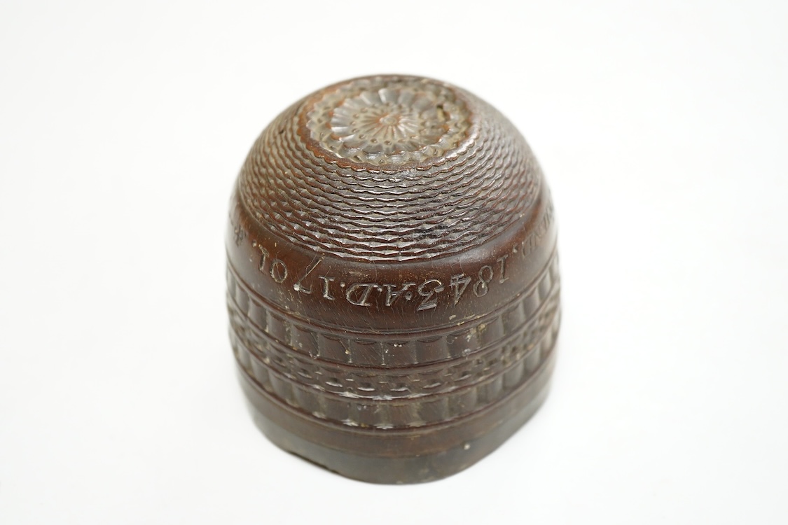 A 19th century or earlier engine-turned lignum vitae tumbler cup, engraved ‘Presented to M. S. Jones by a Friend 1834 AD 1701 +’, 6.5cm high, by repute found on the roof plate of Kenwood house London in 2012, during reno